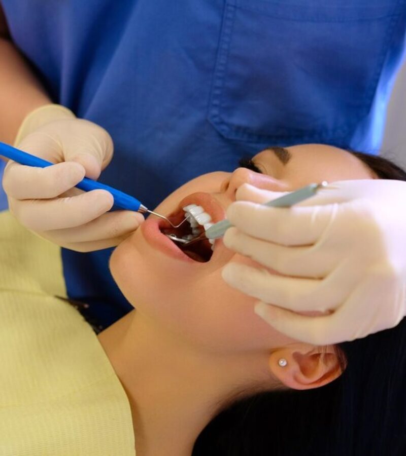 dentist-hands-working-young-woman-patient-with-dental-tools_613910-6133