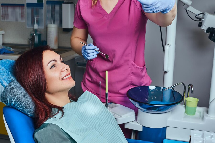 young-redhead-woman-having-examination-while-sitting-dental-chair-clinic_613910-17749