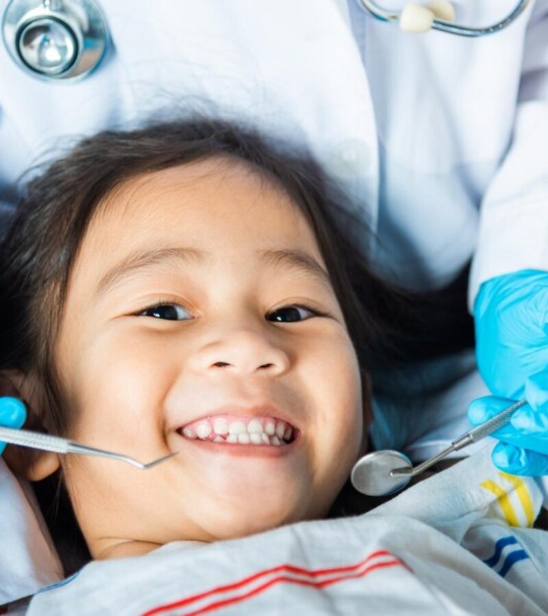 doctor-examines-oral-cavity-little-child-uses-mouth-mirror-checking-teeth-cavity_143683-4517